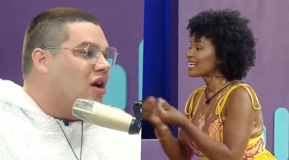 Erick, usando moletom branco e óculos de grau, discutindo com Natália, que usa um vestido amarelo com rosa. Os dois são participantes de A Grande Conquista, reality show da Record.